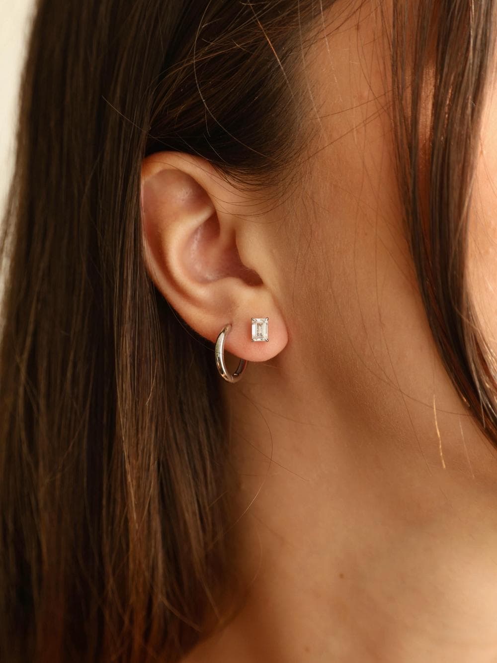 Emerald Cut Stud Earrings worn on ear