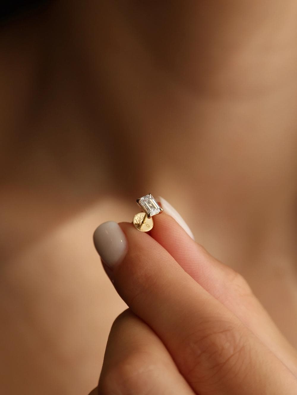 Emerald Cut Stud Earrings detail on finger