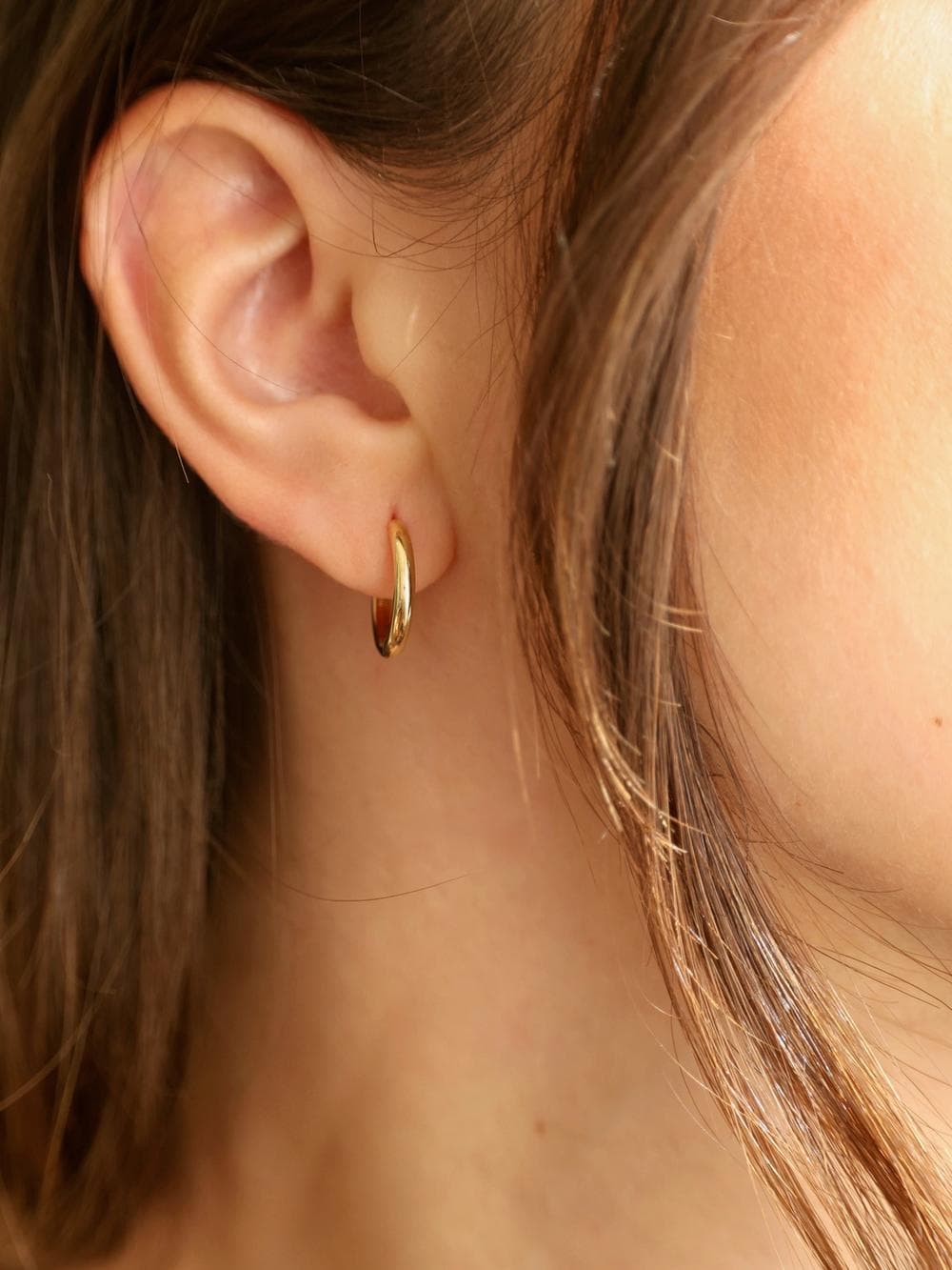 Huggie Hoop Earrings worn on ear