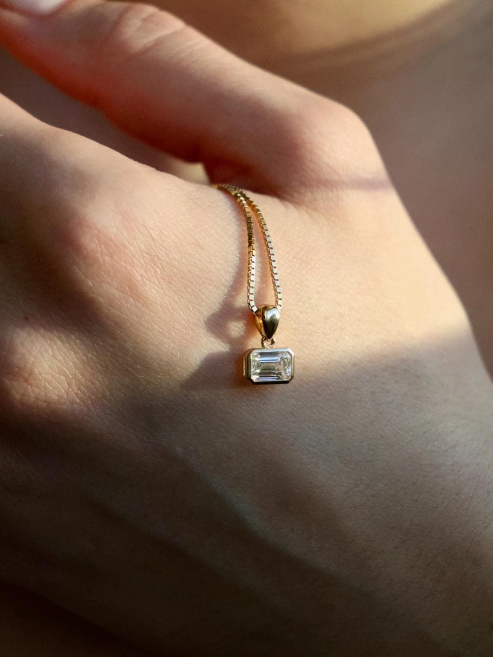Emerald Cut Pendant detail on hand