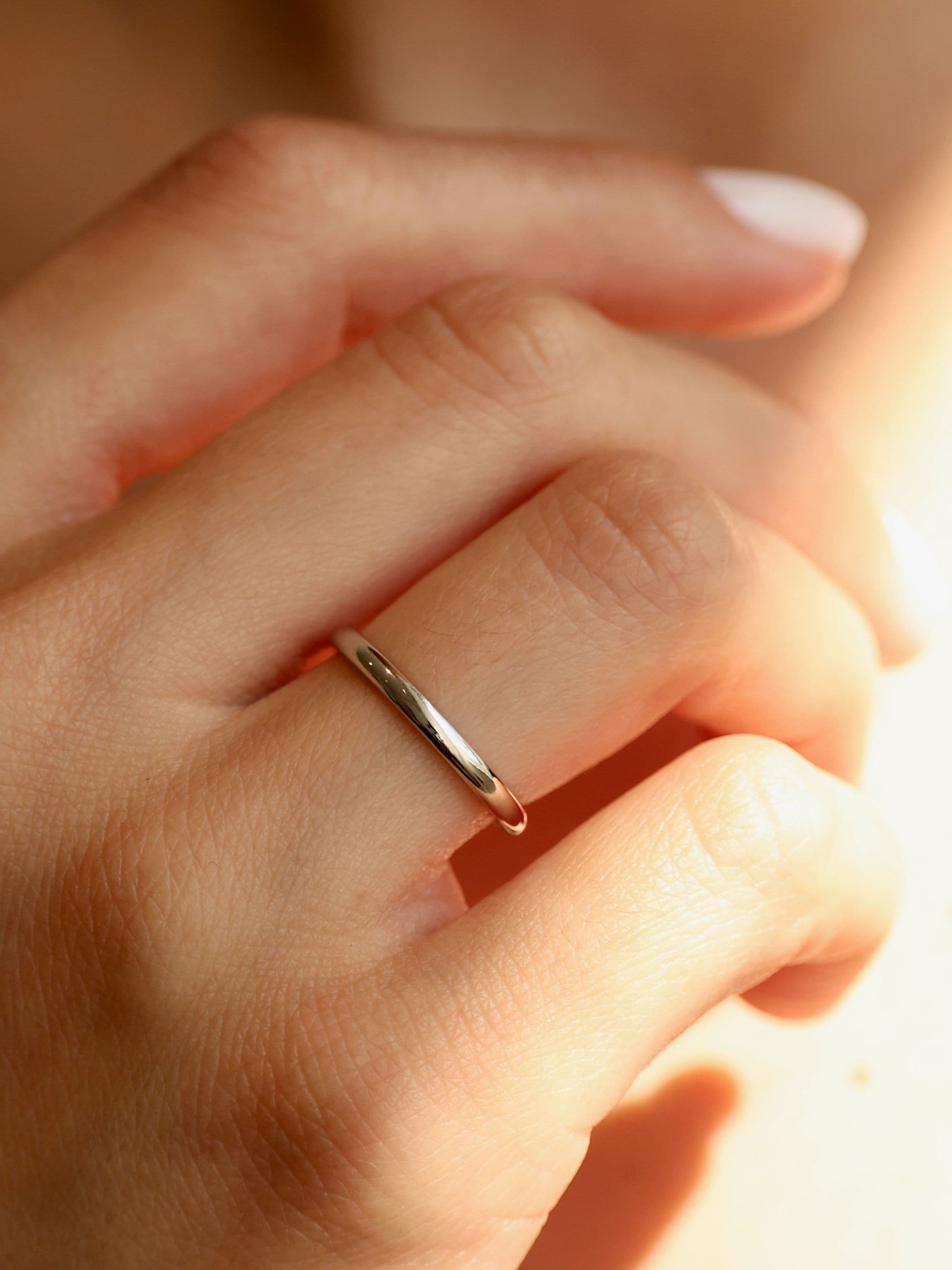 Classic 2 mm half-round wedding ring with hand, white gold