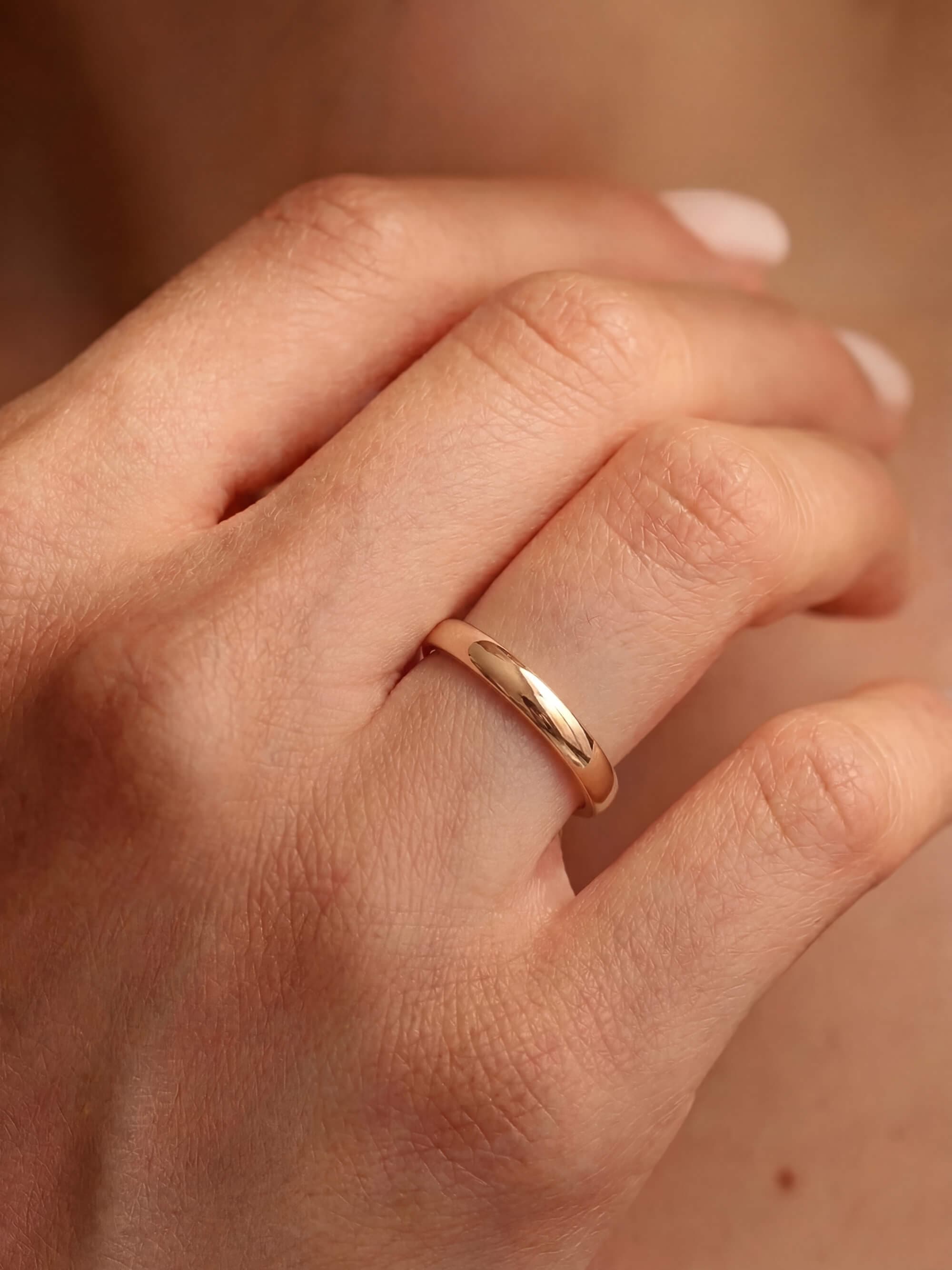 Classic 3 mm half-round wedding band on hand
